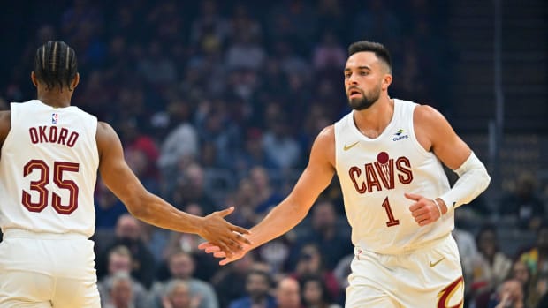 CLEVELAND, OHIO - OCTOBER 12: Isaac Okoro #35 celebrates with Max Strus #1 of the Cleveland Cavaliers during the first quarter of a preseason game against the Orlando Magic at Rocket Mortgage Fieldhouse on October 12, 2023 in Cleveland, Ohio. The Magic defeated the Cavaliers 108-105. 